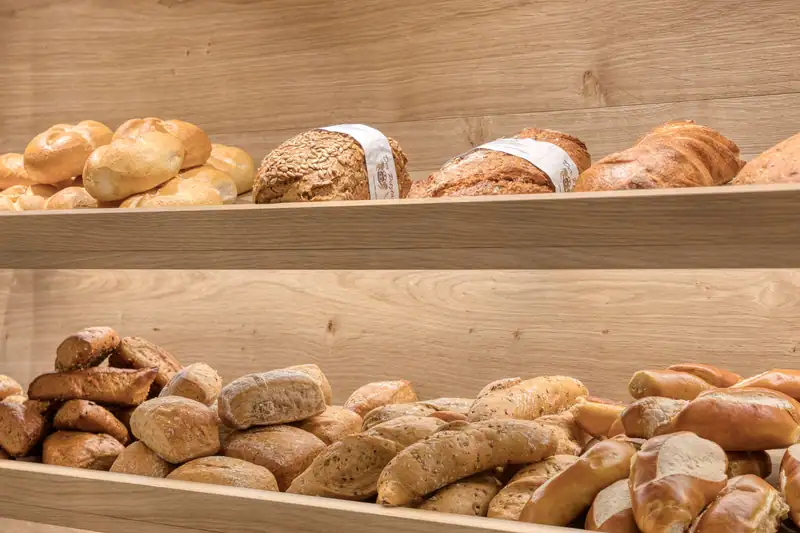 Bread and pastries from the local baker on wooden shelves