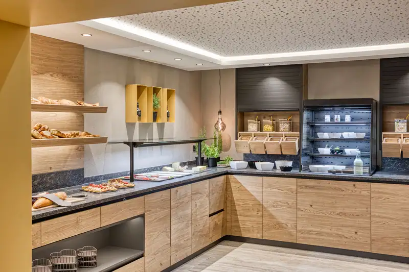 Breakfast buffet with bread, cheese, muesli station and herbs