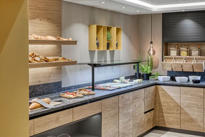 The GenussZone: breakfast buffet with bread shelf, cold meats, cheese, pastries and muesli station