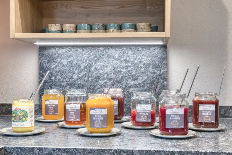 Homemade jams and dandelion honey in jars with Sonnblick labels