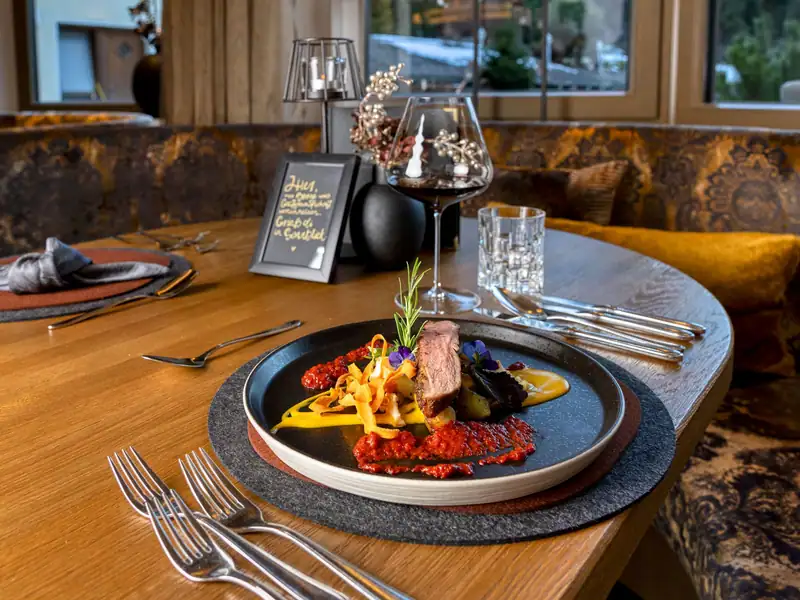 Plated duck breast with red wine on a wooden table in the parlour