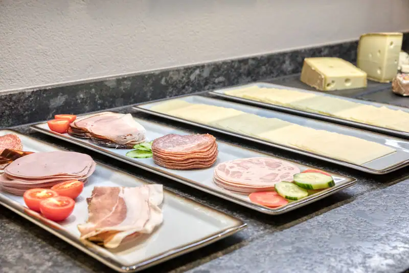 Cold meat and cheese platters with tomatoes and cucumbers