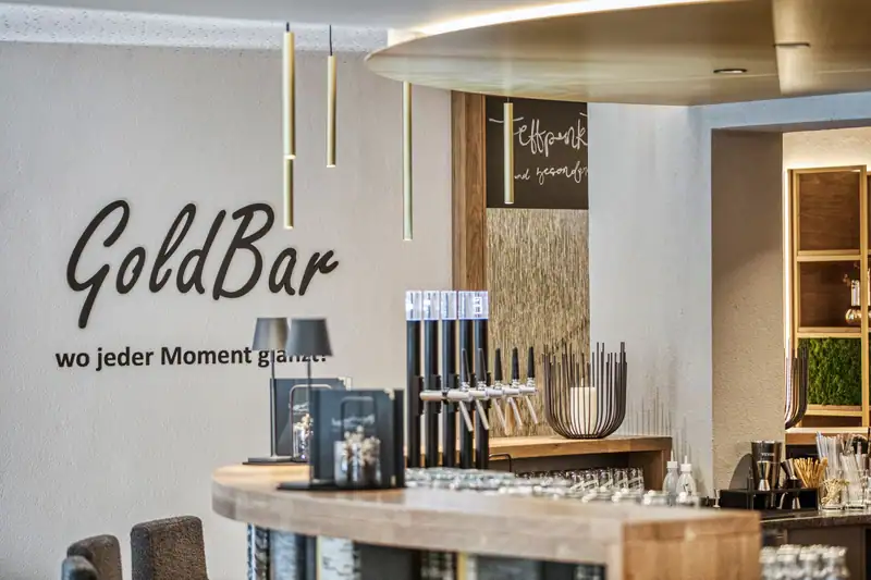Beer taps and bar menus at the GoldBar with golden pendant lights