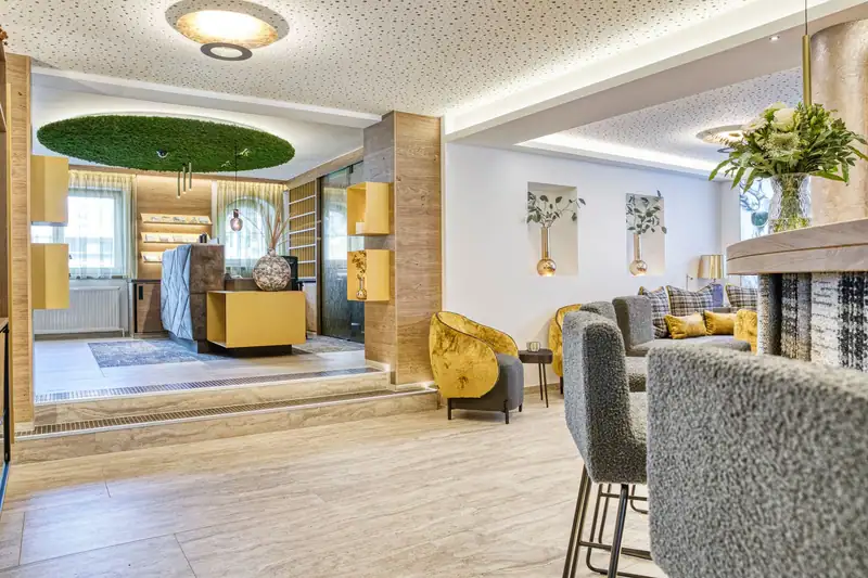 Lobby with a view of reception and golden armchairs