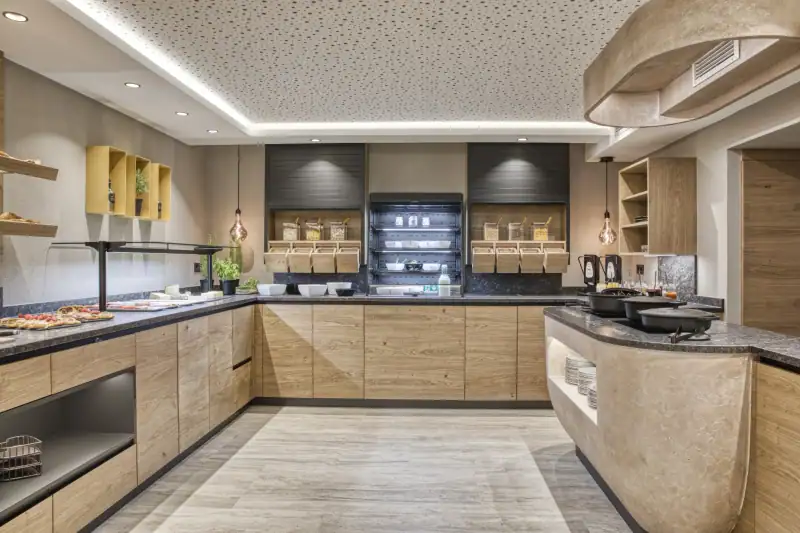 The new breakfast area with wooden fronts, muesli dispensers, chilled display and acoustic ceiling with light strip
