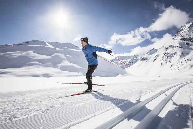 Cross-country skier skating on the groomed glacier trail