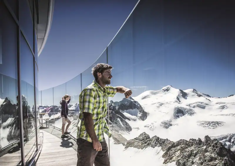 Panoramic terrace of Café 3440 with a view of the snow-covered Wildspitze in summer