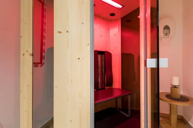 Infrared cabin made of light wood in red light