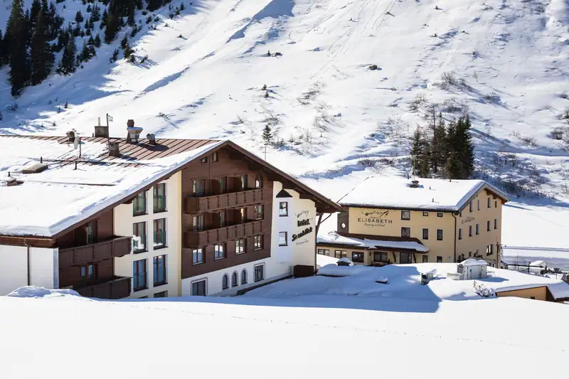 Hotel Sonnblick and B&B Elisabeth side by side beneath a deep-snow slope