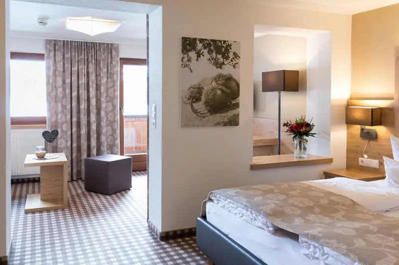 View from the sleeping area through the passage into the living area with balcony door