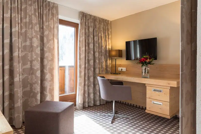 Oak desk with swivel chair, TV and balcony door