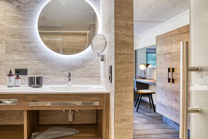 Washbasin with make-up mirror, view from the bathroom into the living area