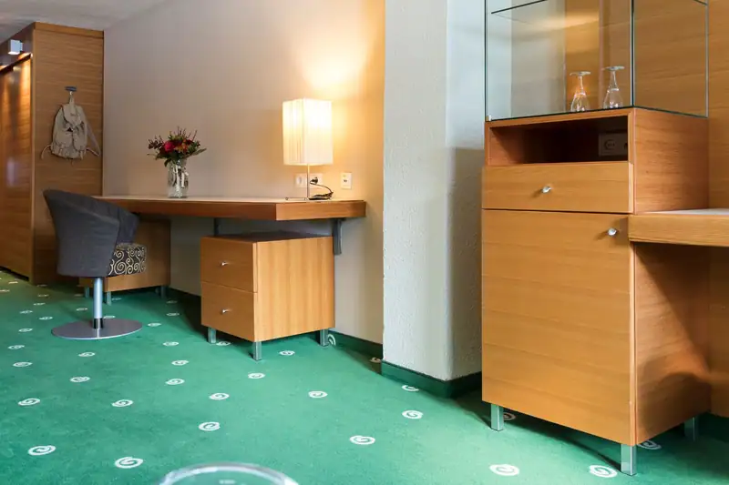 Desk with swivel chair, table lamp and display cabinet