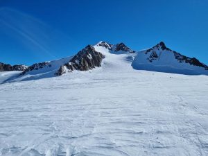 A guided ski touring group ascending the vast Taschachferner glacier on their way to the Wildspitze.