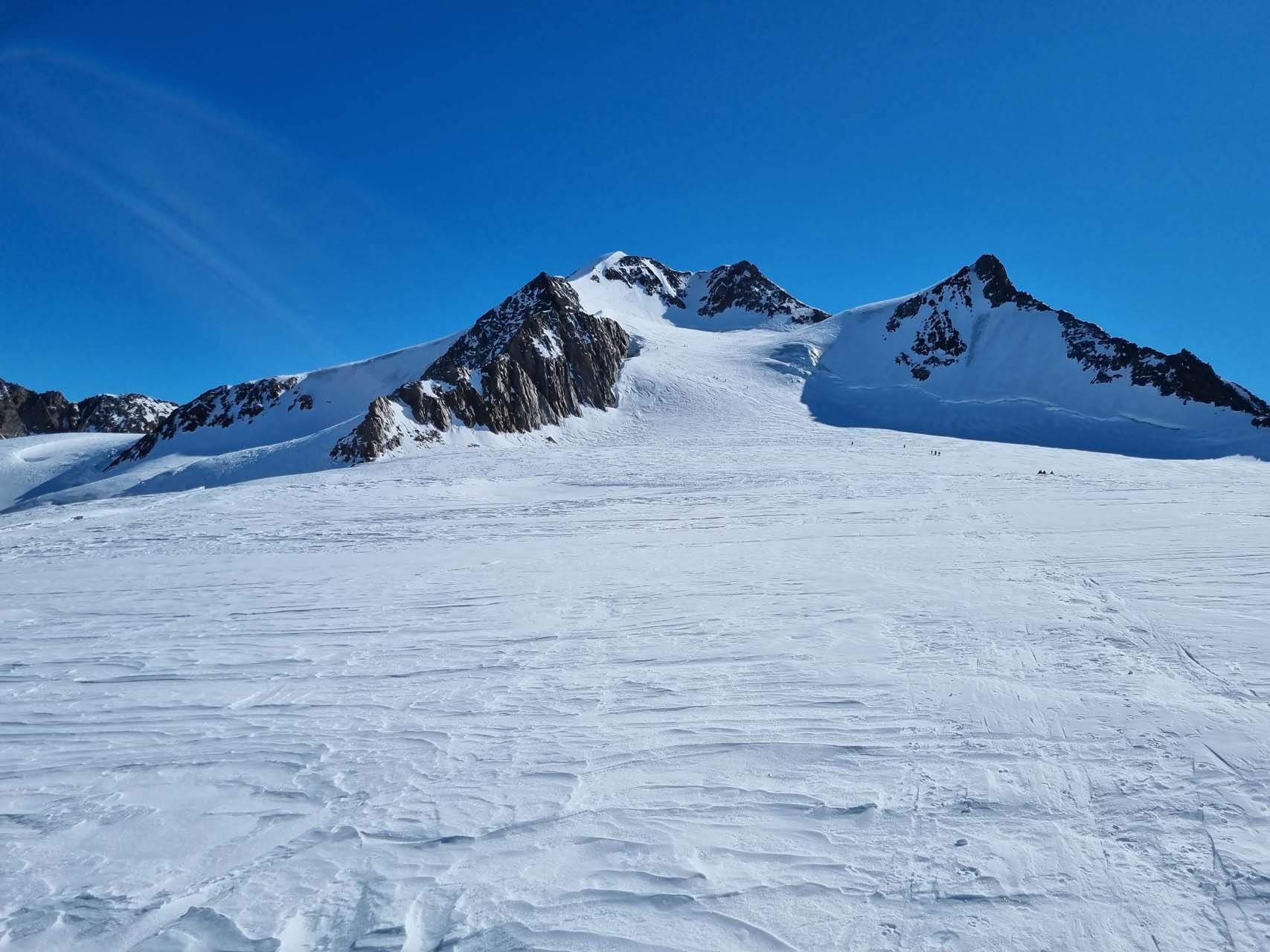 A guided ski touring group ascending the vast Taschachferner glacier on their way to the Wildspitze.